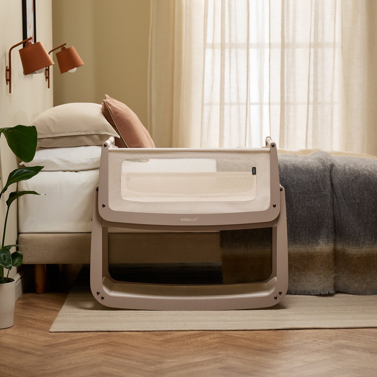 A Mocha Snuzpod5 bedside crib designed for infants, showcasing a modern and safe sleeping environment.