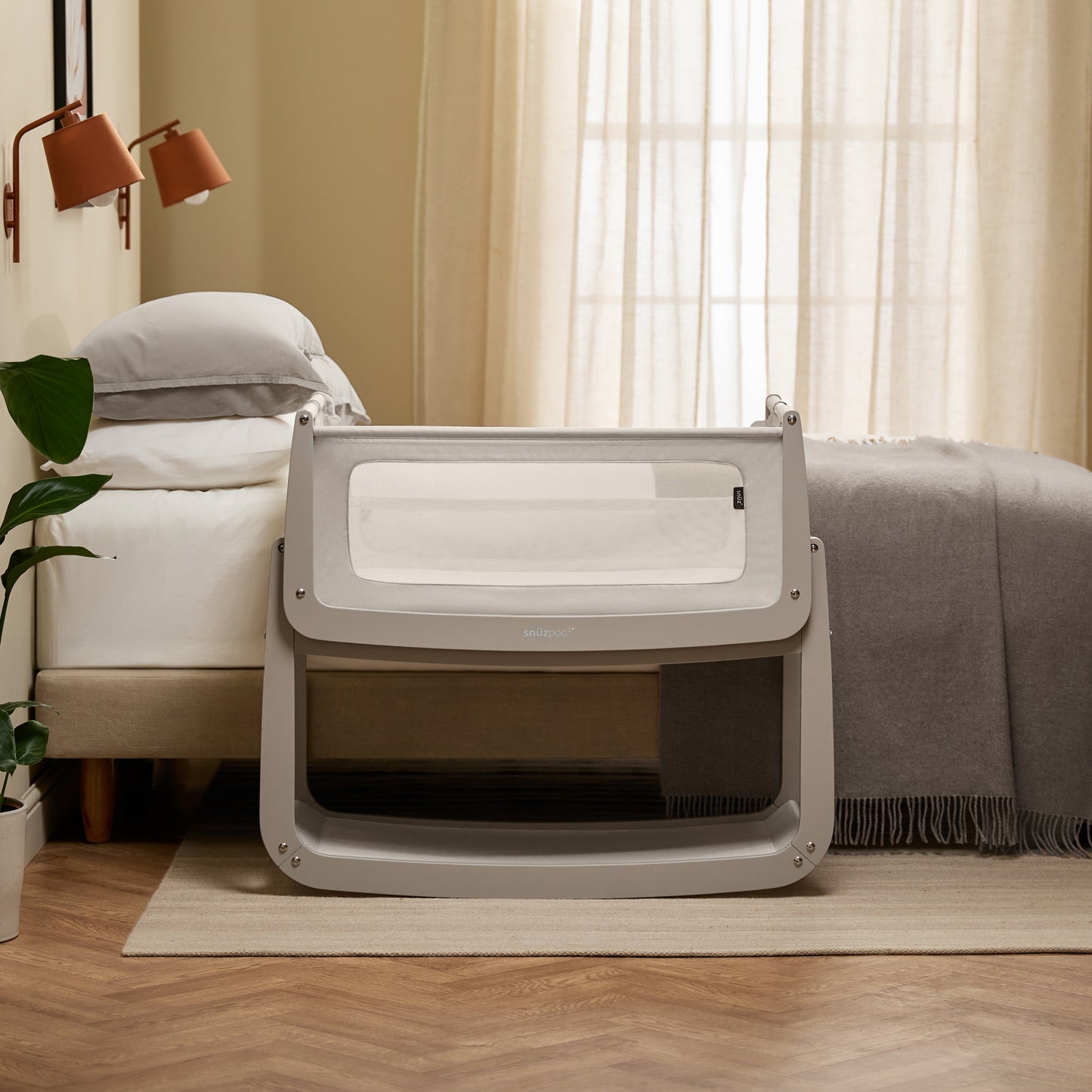 A Pebble Snuzpod5 bedside crib designed for infants, showcasing a modern and safe sleeping environment.