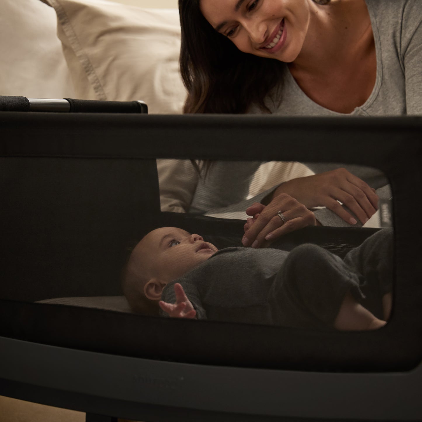 A Graphite Snuzpod5 bedside crib designed for infants, showcasing a modern and safe sleeping environment.