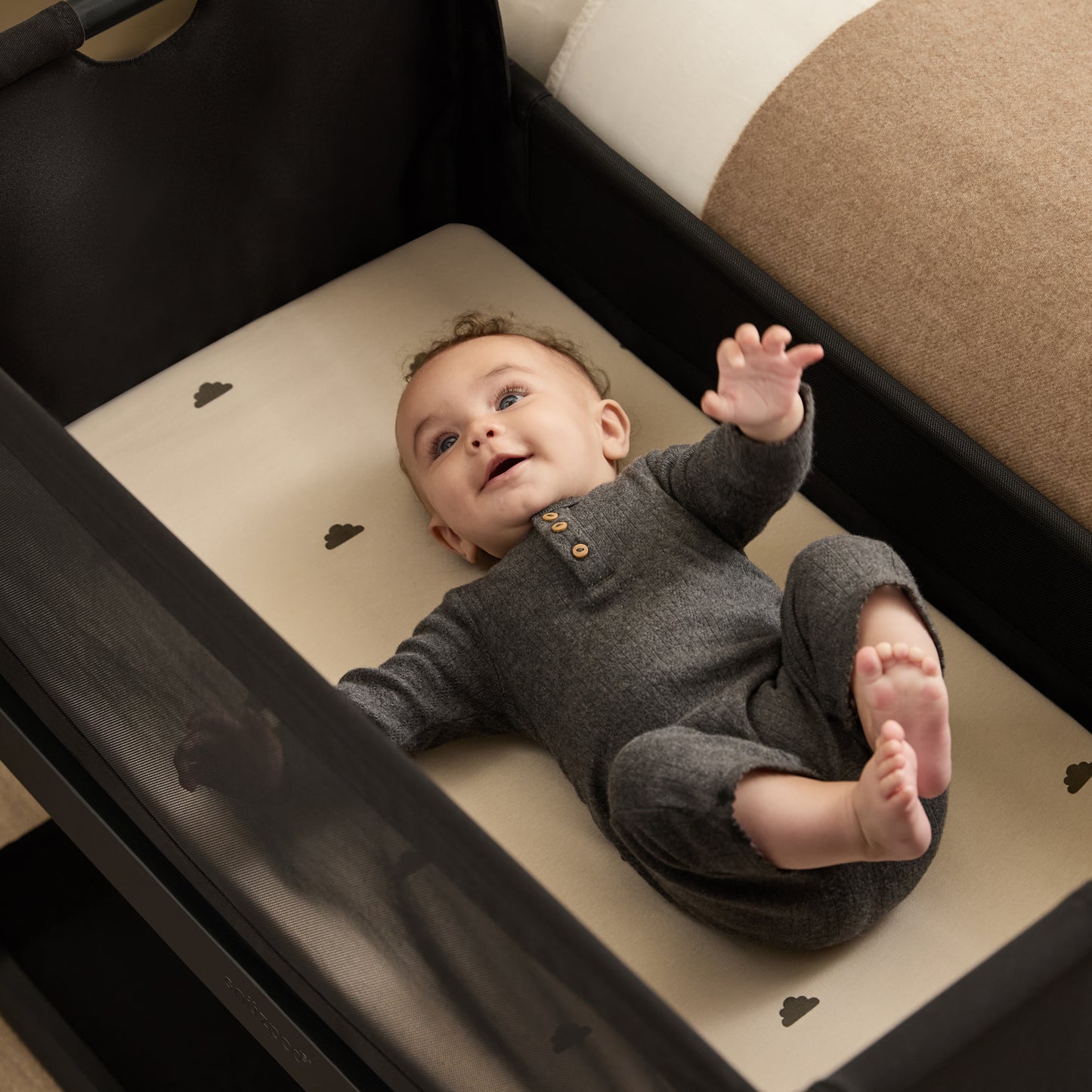 A Graphite Snuzpod5 bedside crib designed for infants, showcasing a modern and safe sleeping environment.