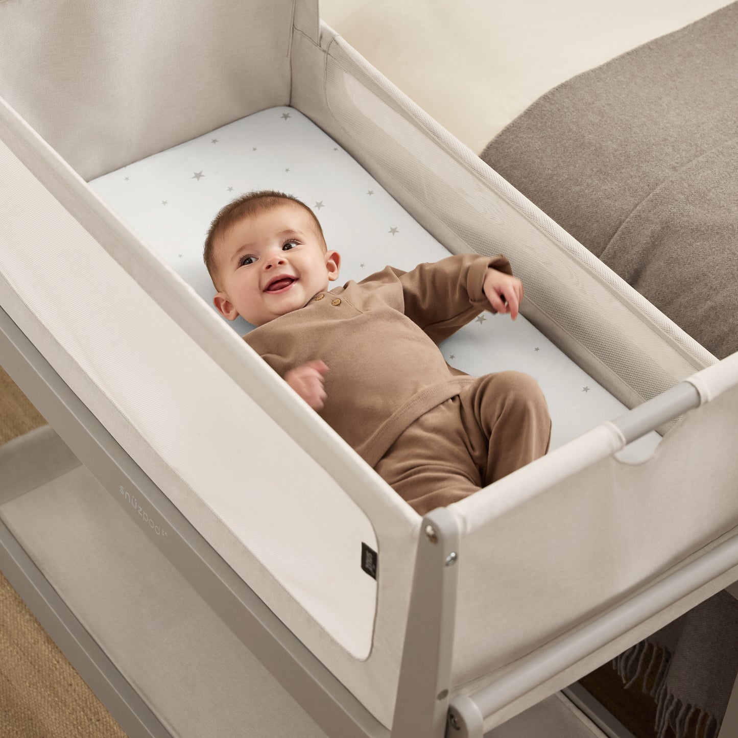 A Pebble Snuzpod5 bedside crib designed for infants, showcasing a modern and safe sleeping environment.