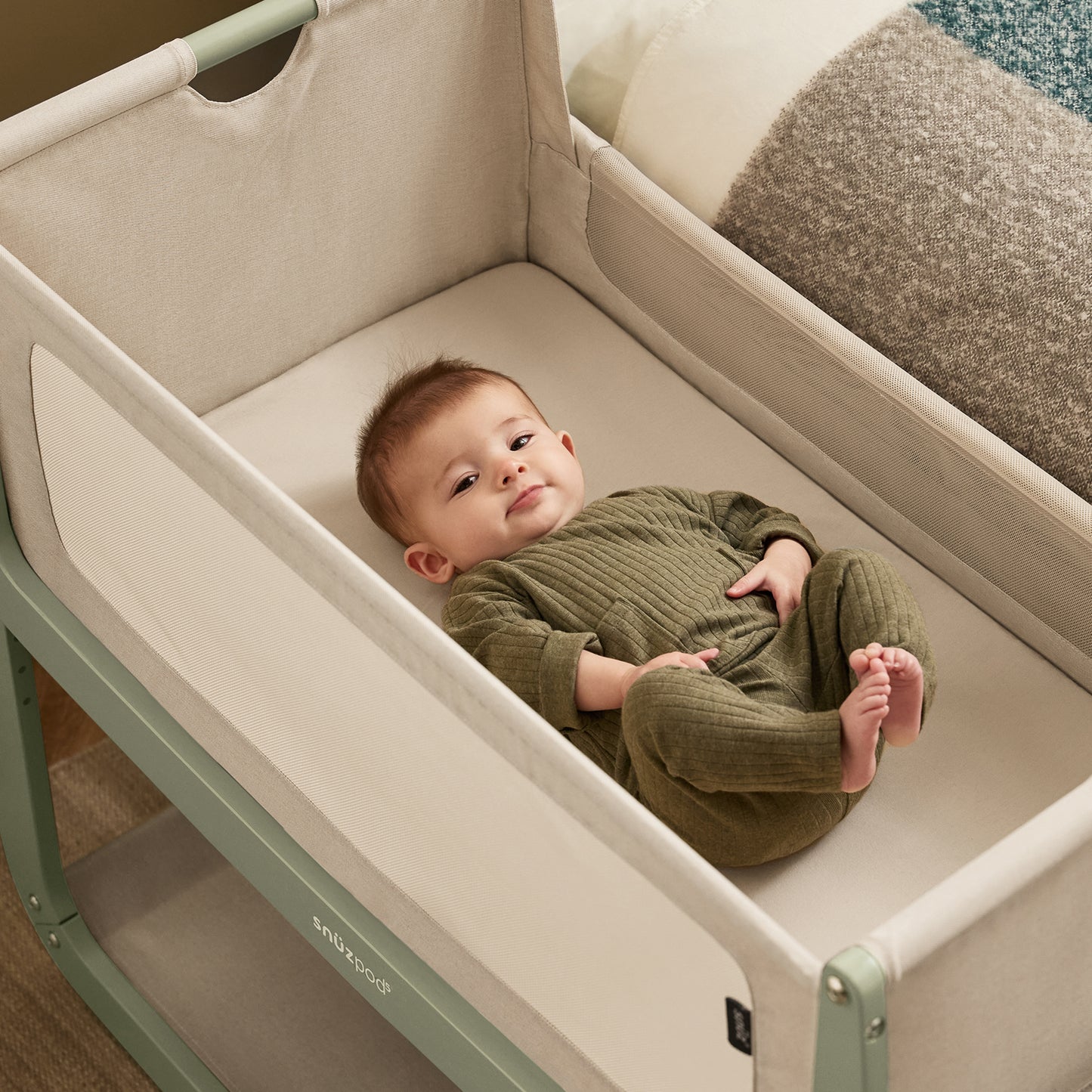 A Sage Snuzpod5 bedside crib designed for infants, showcasing a modern and safe sleeping environment.