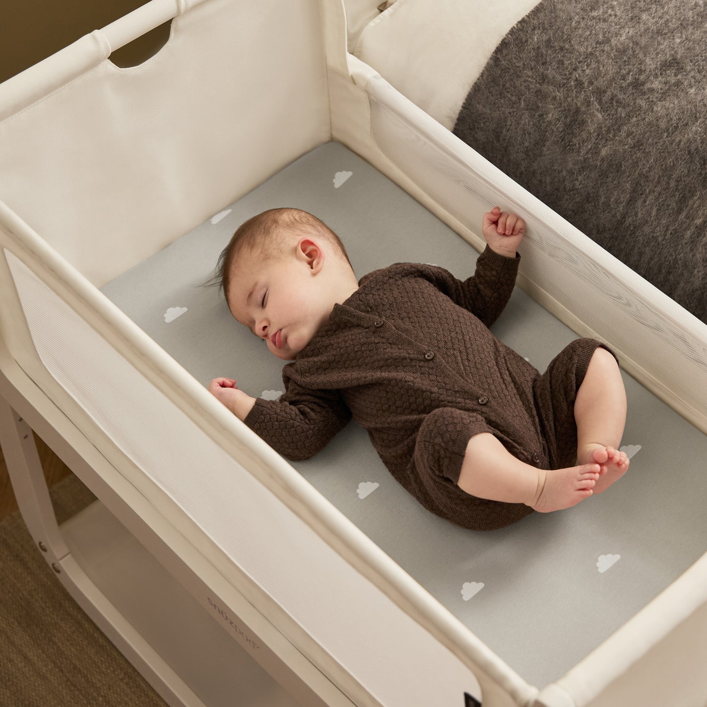 A White Snuzpod5 bedside crib designed for infants, showcasing a modern and safe sleeping environment.