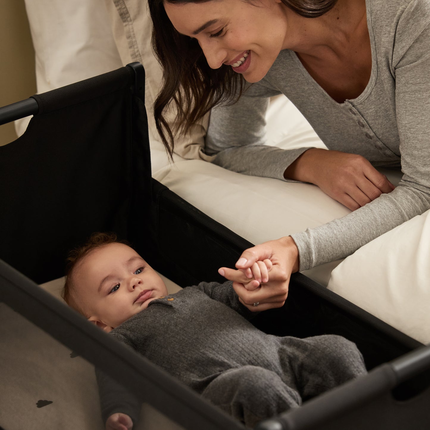 A Graphite Snuzpod5 bedside crib designed for infants, showcasing a modern and safe sleeping environment.