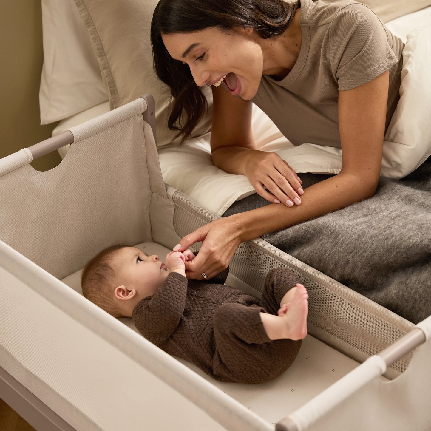 A Mocha Snuzpod5 bedside crib designed for infants, showcasing a modern and safe sleeping environment.