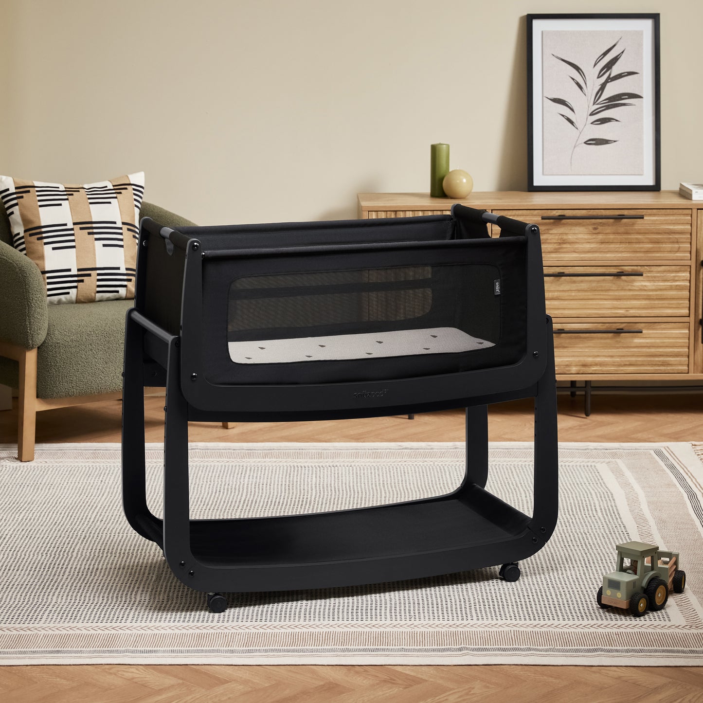 A Graphite Snuzpod5 bedside crib designed for infants, showcasing a modern and safe sleeping environment.