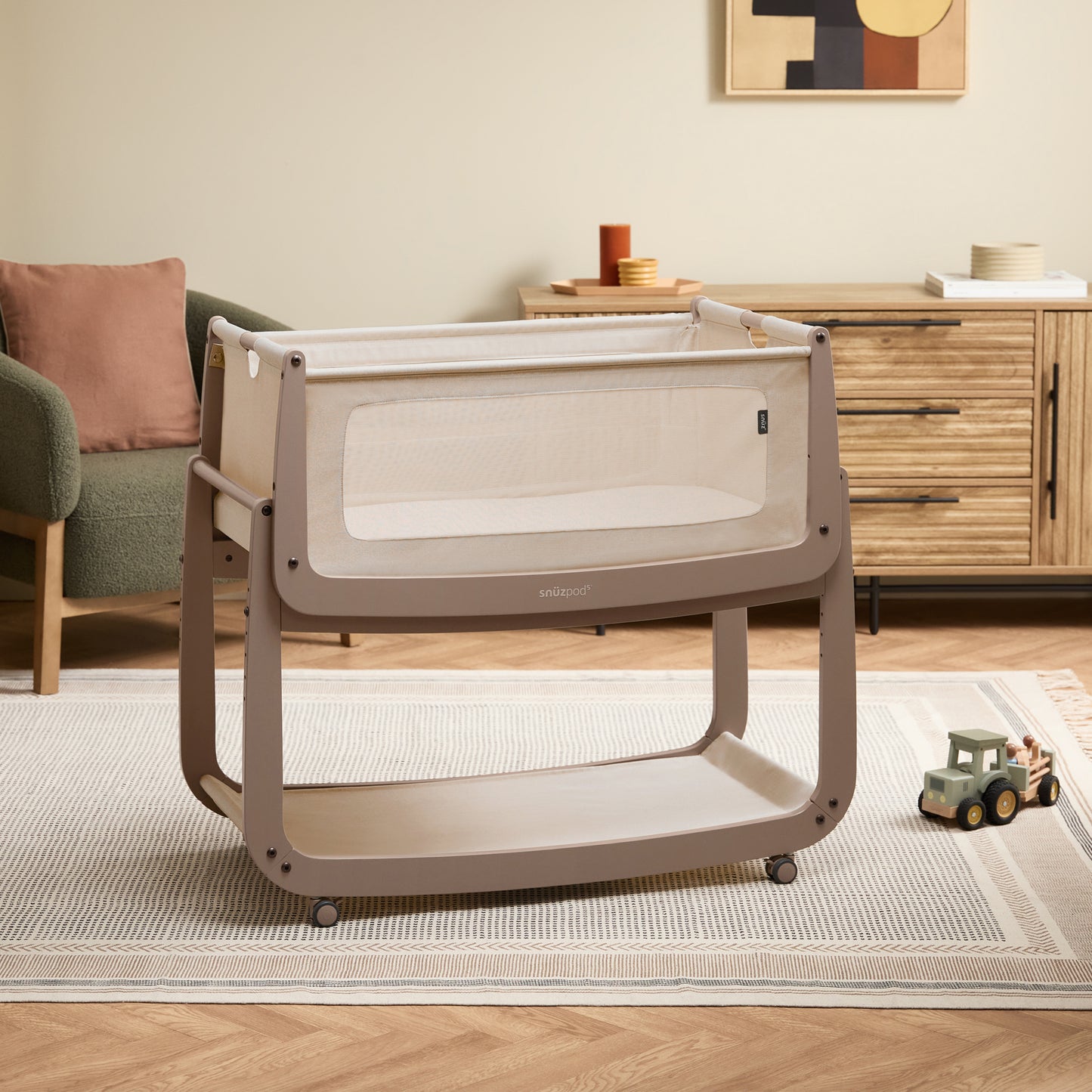 A Mocha Snuzpod5 bedside crib designed for infants, showcasing a modern and safe sleeping environment.