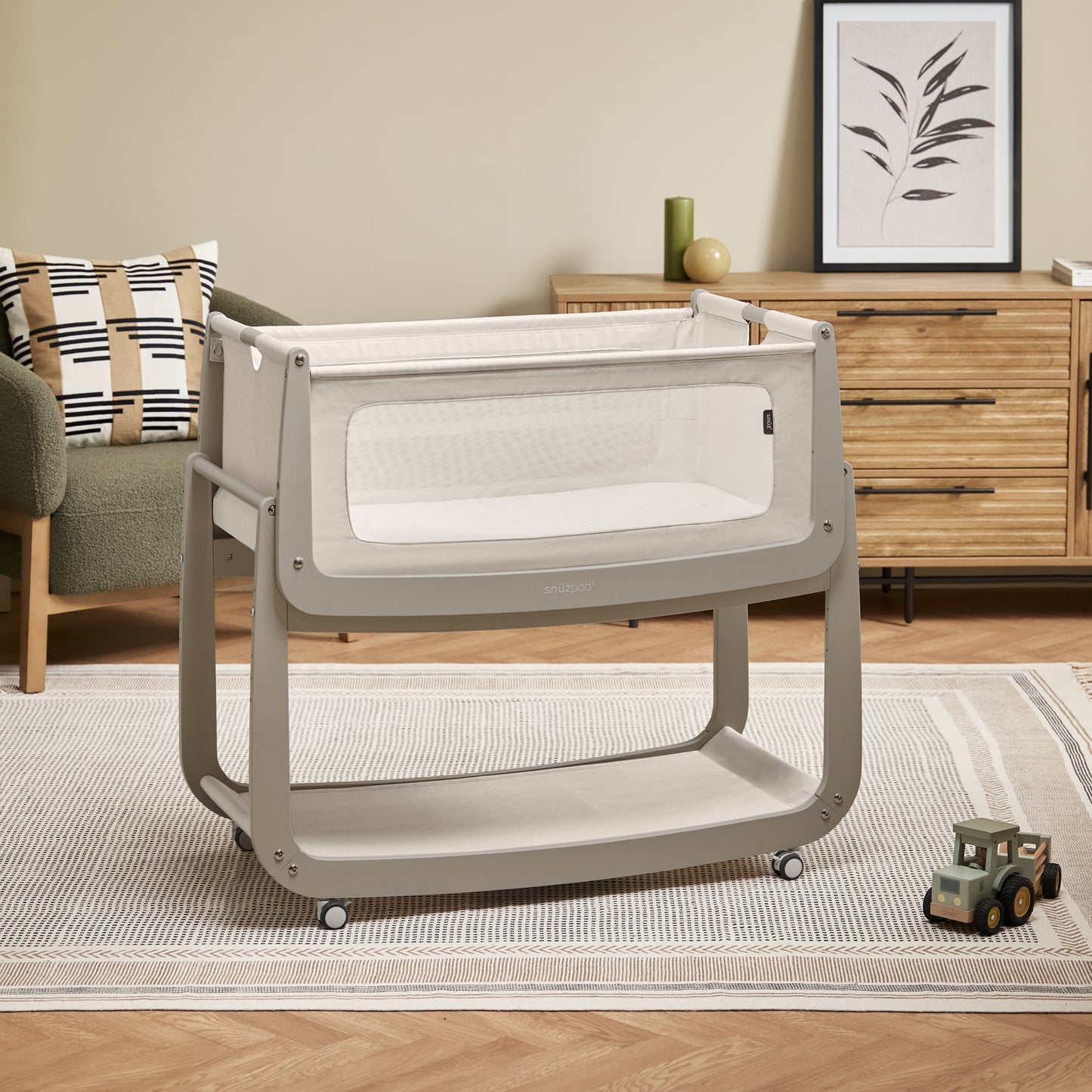 A Pebble Snuzpod5 bedside crib designed for infants, showcasing a modern and safe sleeping environment.