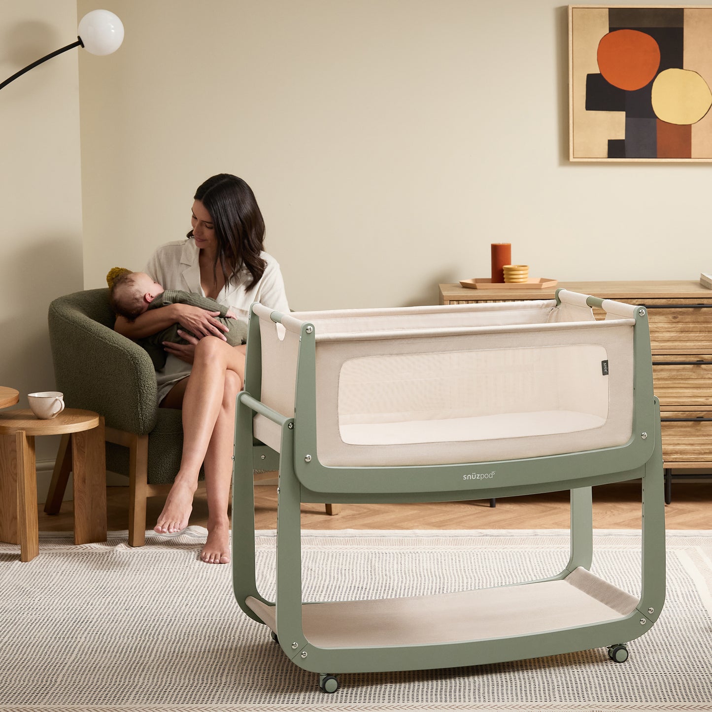 A Sage Snuzpod5 bedside crib designed for infants, showcasing a modern and safe sleeping environment.