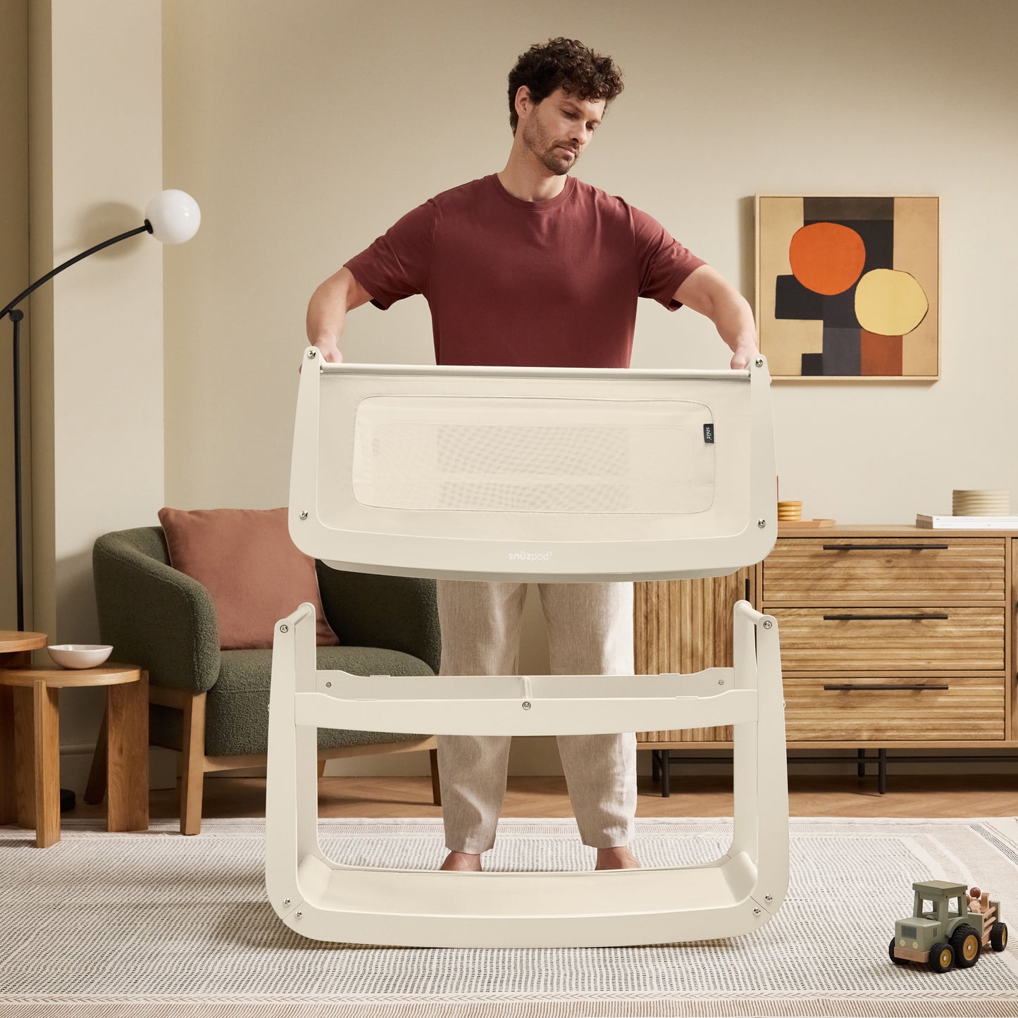 A Cashmere Snuzpod5 bedside crib designed for infants, showcasing a modern and safe sleeping environment.