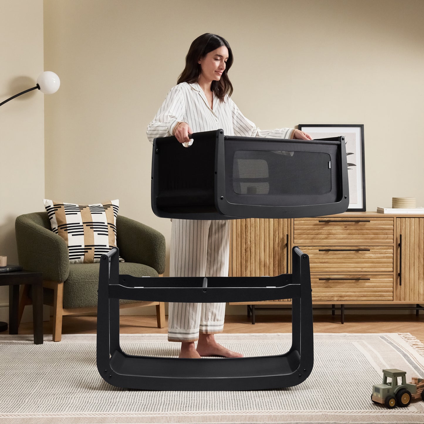 A Graphite Snuzpod5 bedside crib designed for infants, showcasing a modern and safe sleeping environment.