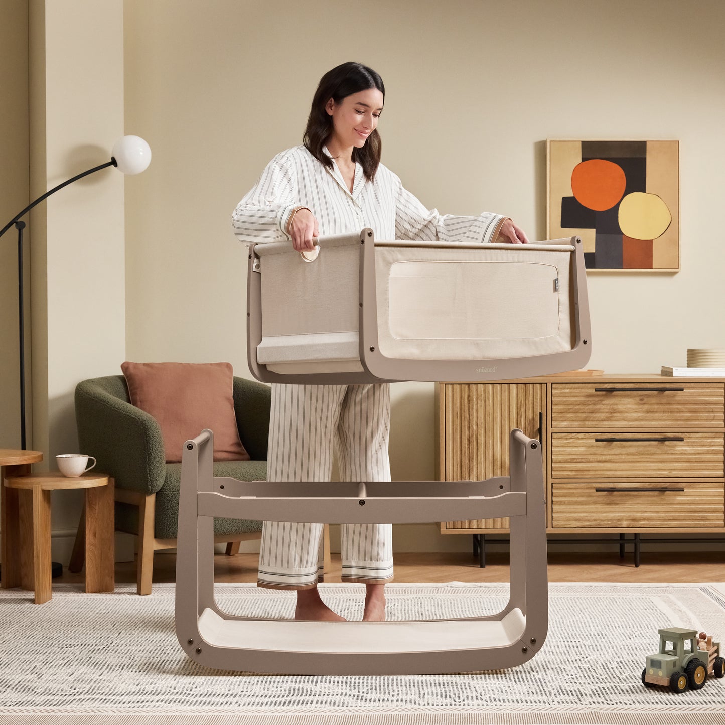 A Mocha Snuzpod5 bedside crib designed for infants, showcasing a modern and safe sleeping environment.