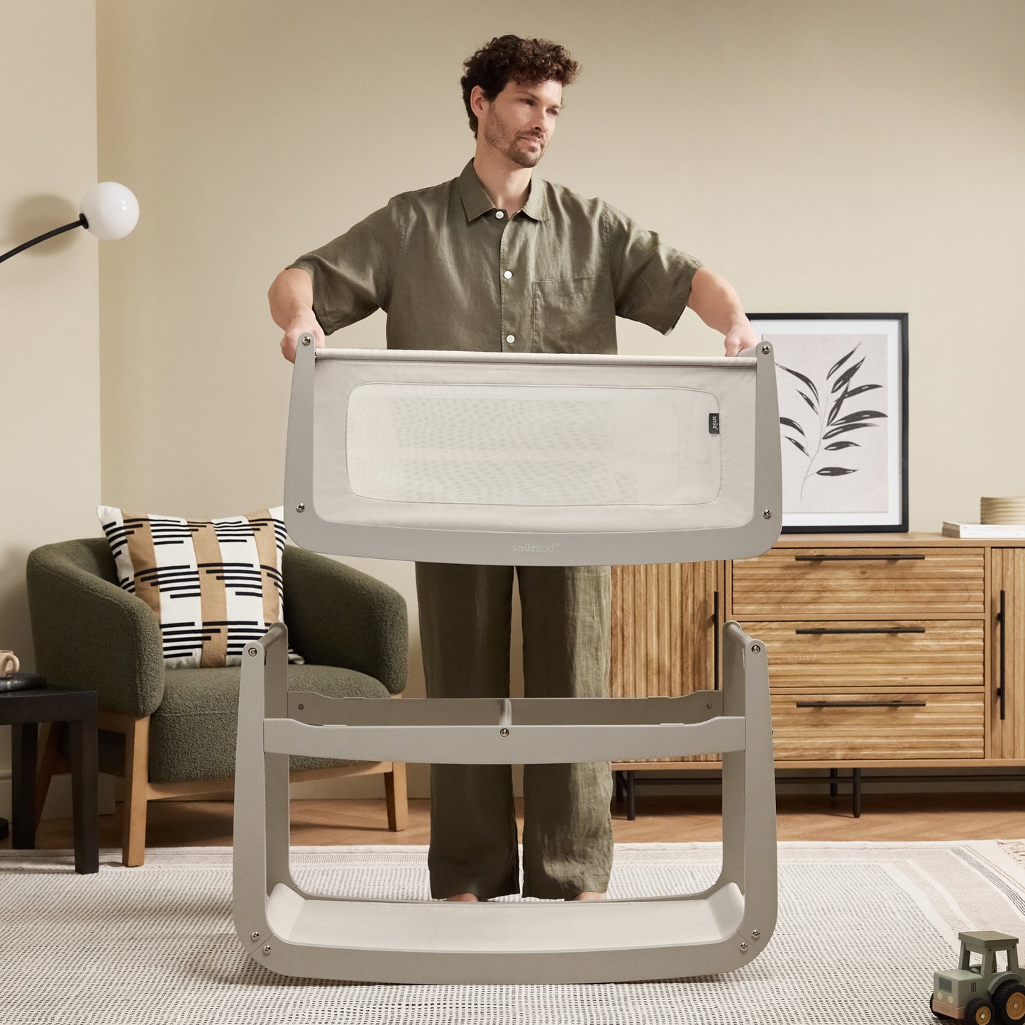 A Pebble Snuzpod5 bedside crib designed for infants, showcasing a modern and safe sleeping environment.
