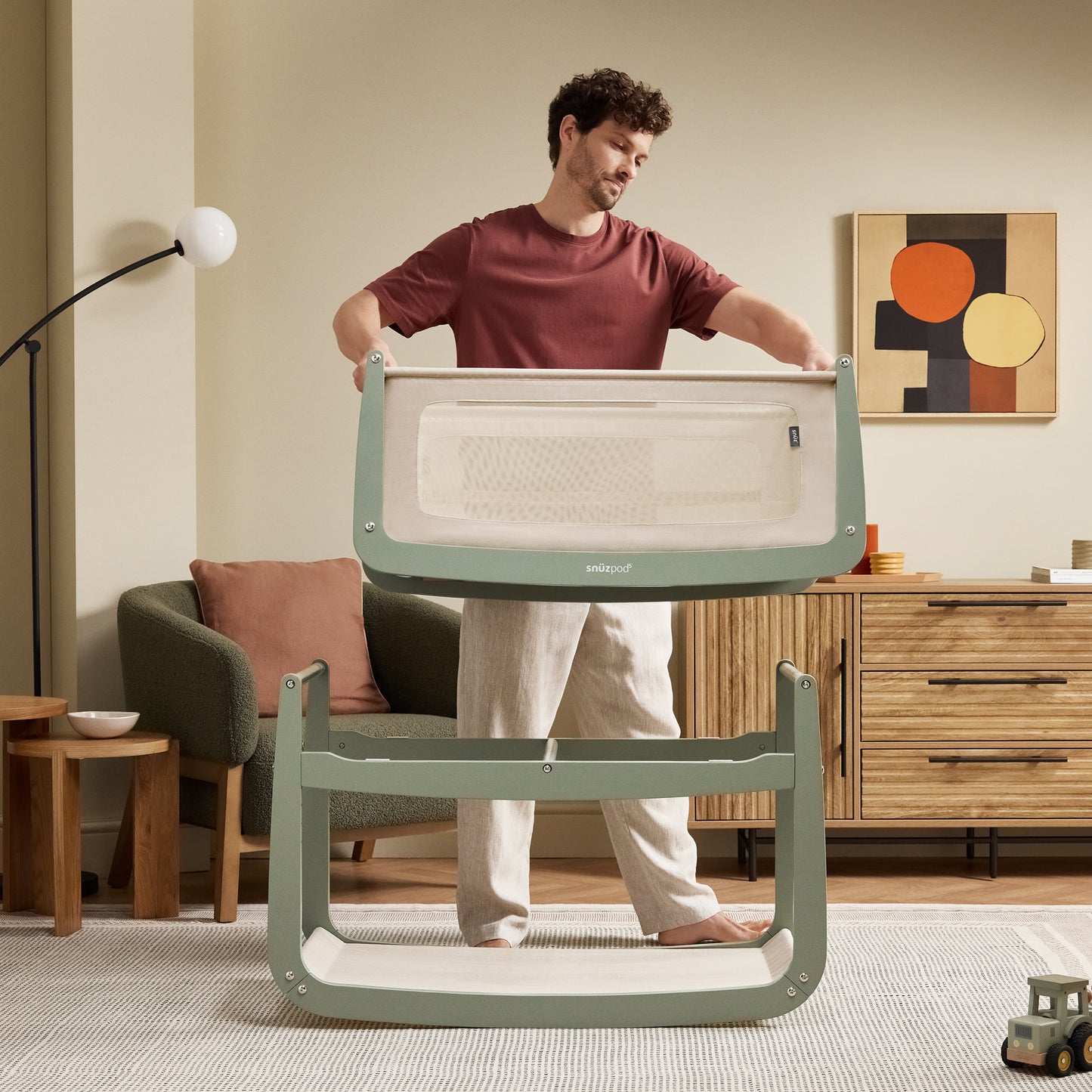 A Sage Snuzpod5 bedside crib designed for infants, showcasing a modern and safe sleeping environment.