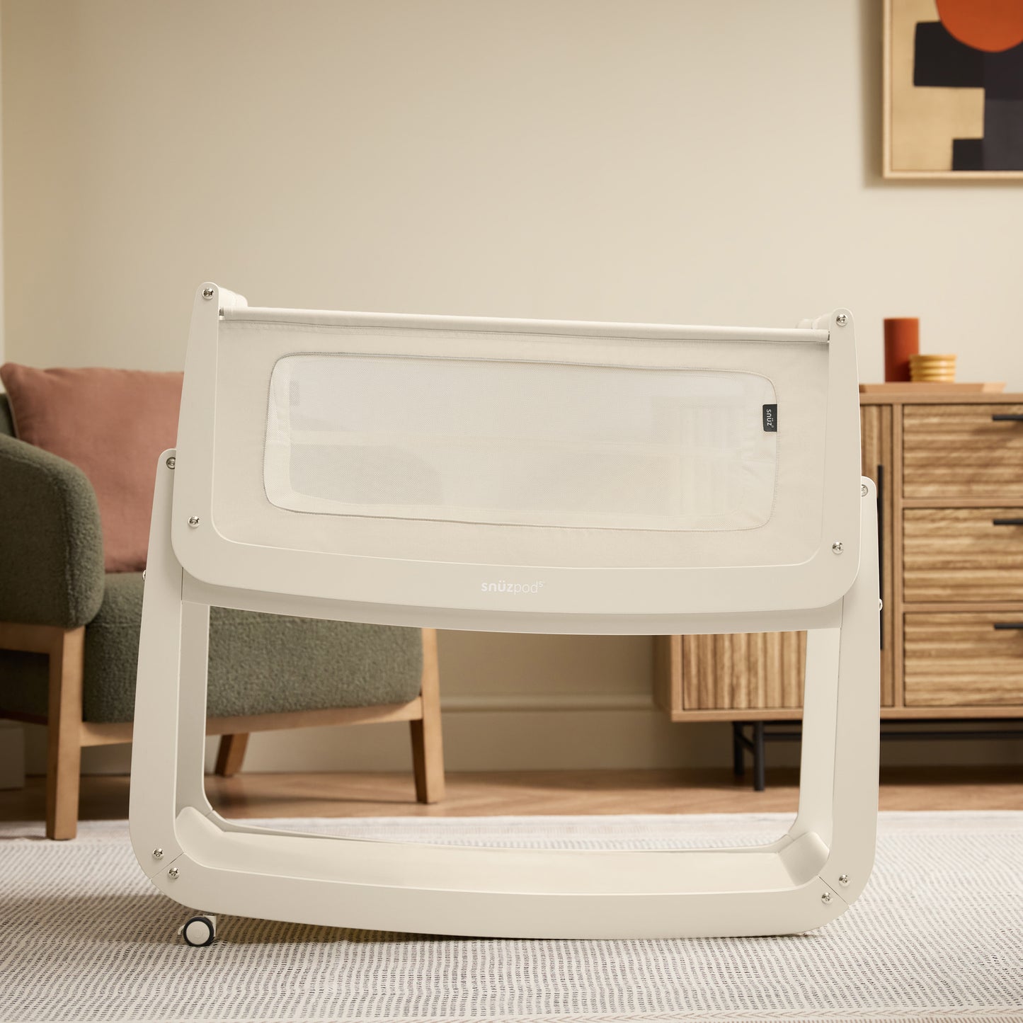 A Cashmere Snuzpod5 bedside crib designed for infants, showcasing a modern and safe sleeping environment.
