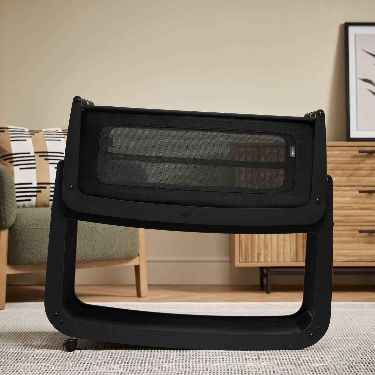 A Graphite Snuzpod5 bedside crib designed for infants, showcasing a modern and safe sleeping environment.