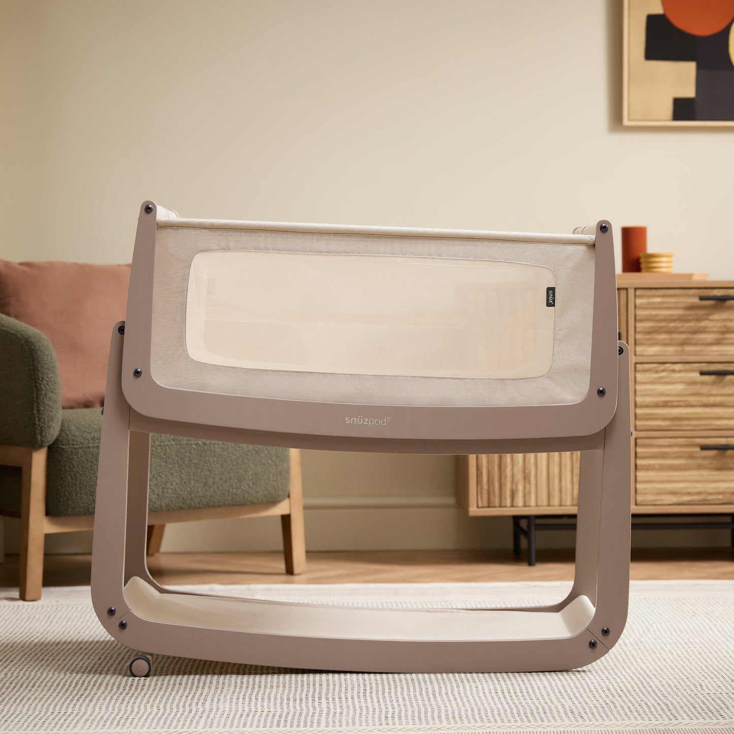 A Mocha Snuzpod5 bedside crib designed for infants, showcasing a modern and safe sleeping environment.