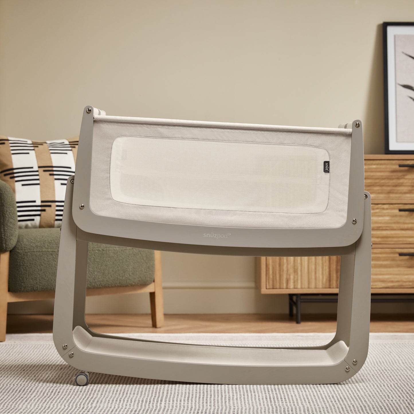 A Pebble Snuzpod5 bedside crib designed for infants, showcasing a modern and safe sleeping environment.