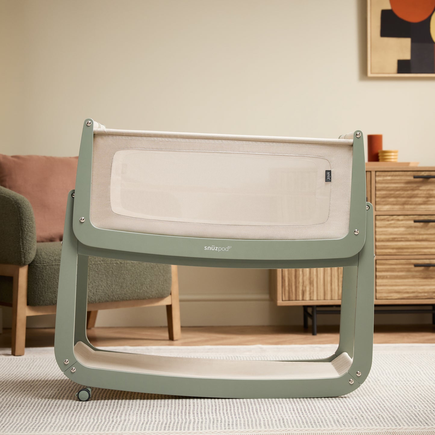 A Sage Snuzpod5 bedside crib designed for infants, showcasing a modern and safe sleeping environment.