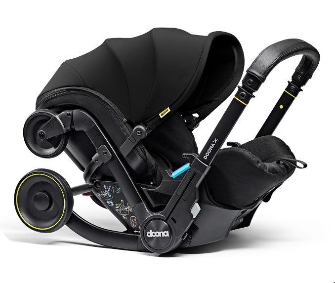 A stylish Doona X car seat in nitro black, for a modern infant safety solution.