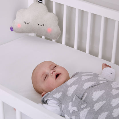 Snuz cloud hanging from crib as baby sleeps