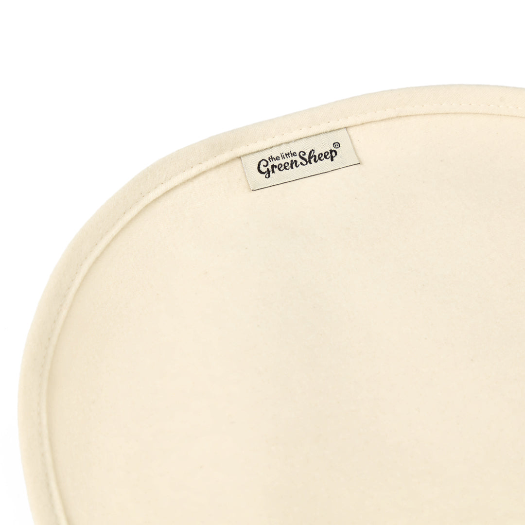 Little green sheep organic mattress protector for moses basket of pram, in a natural beige colour.