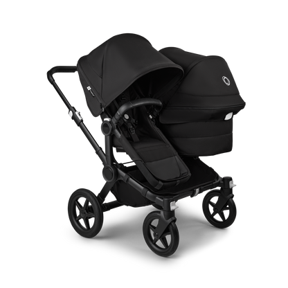 Midnight Black Bugaboo Donkey 5 stroller with 2 x seat and1 x carrycot fabrics, designed for easy folding and adaptable for mono, duo or twin configurations.