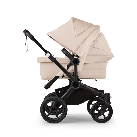 Desert Taupe Bugaboo Donkey 5 stroller with 2 x seat and1 x carrycot fabrics, designed for easy folding and adaptable for mono, duo or twin configurations.