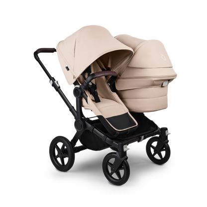 Desert Taupe Bugaboo Donkey 5 stroller with 2 x seat and1 x carrycot fabrics, designed for easy folding and adaptable for mono, duo or twin configurations.