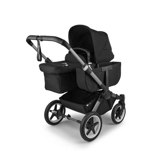 Midnight Black Bugaboo Donkey 5 stroller with seat and carrycot fabrics, designed for easy folding and adaptable for duo or twin configurations.