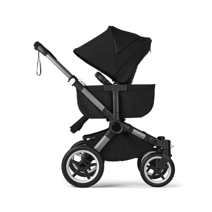 Midnight Black Bugaboo Donkey 5 stroller with seat and carrycot fabrics, designed for easy folding and adaptable for duo or twin configurations.