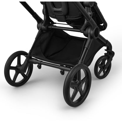 Bugaboo Cub stroller and carrycot in forest green with black chassis.