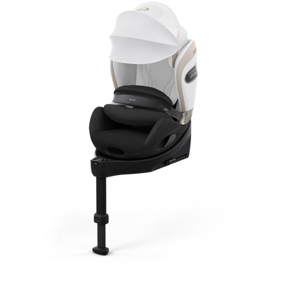 Cybex anoris Si car seat with airbag in off white style colour, with isofix base attatched.