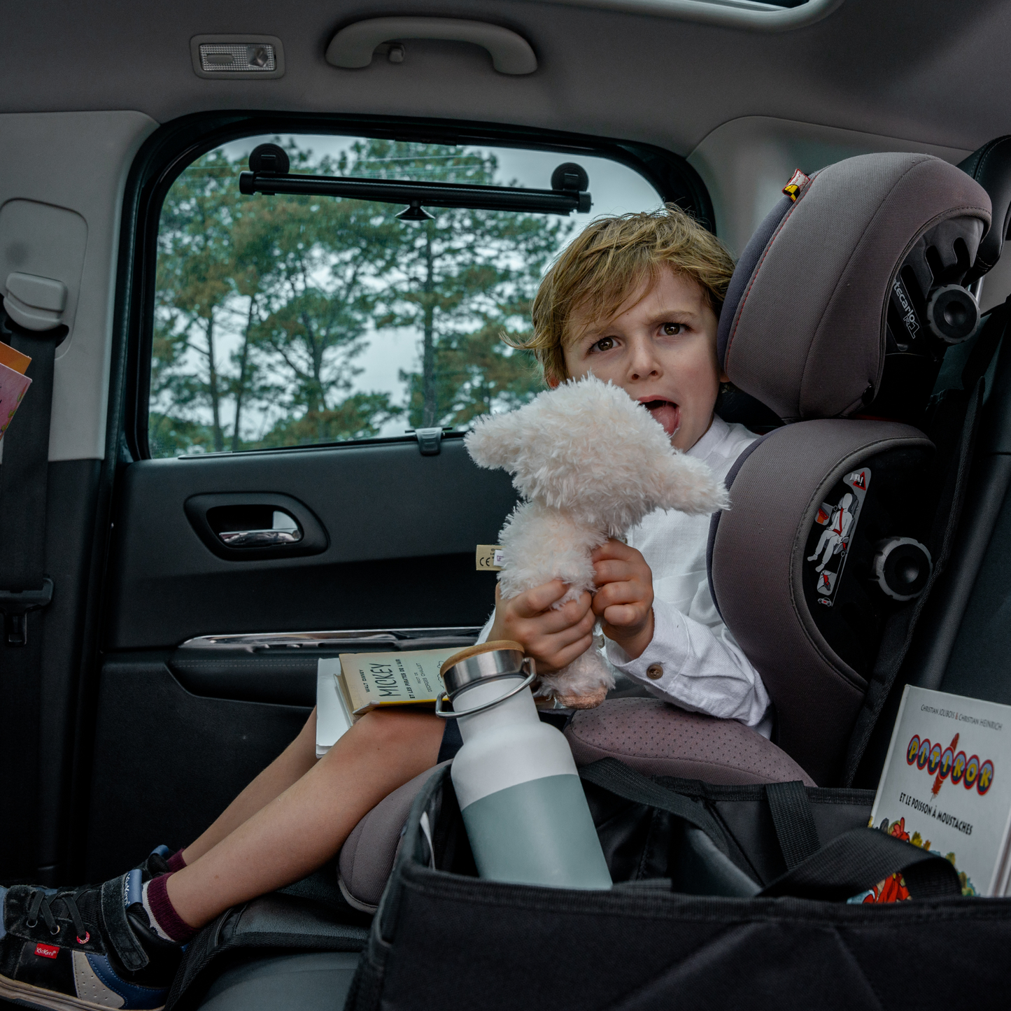 Car seat cover with storage pockets, designed as a seat protector for triple use and enhanced functionality.