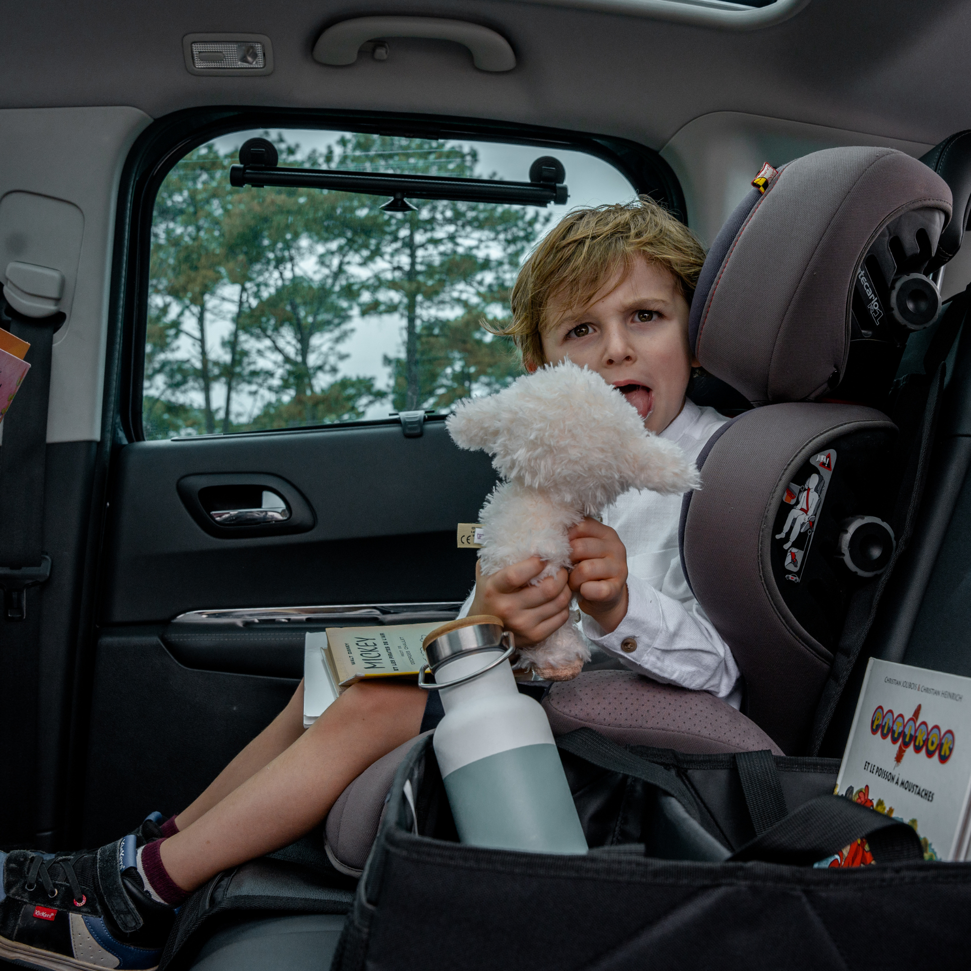 Car seat cover with storage pockets, designed as a seat protector for triple use and enhanced functionality.