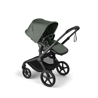 The foreset green Bugaboo Fox5 pushchair, equipped with a seat and carrycot fabric, offers a compact fold for all-terrain use.