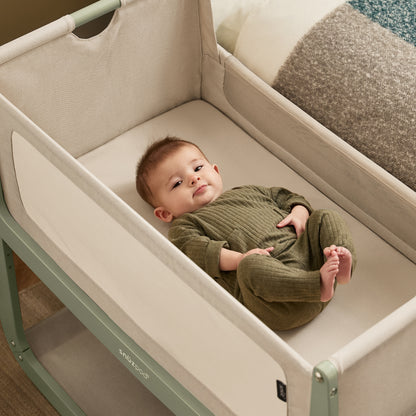 A Sage Snuzpod5 bedside crib designed for infants, showcasing a modern and safe sleeping environment.