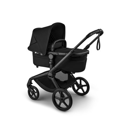 The Heritage Black Bugaboo Fox5 pushchair, equipped with a seat and carrycot fabric, offers a compact fold for all-terrain use.