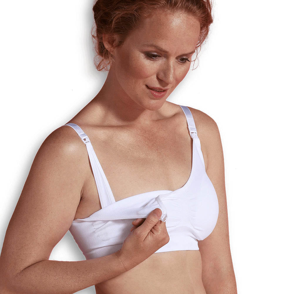 A seamless white maternity and nursing bra top with extenders for maximum skin-to-skin contact.