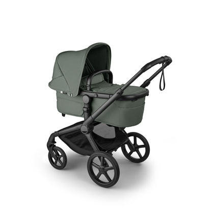 The foreset green Bugaboo Fox5 pushchair, equipped with a seat and carrycot fabric, offers a compact fold for all-terrain use.