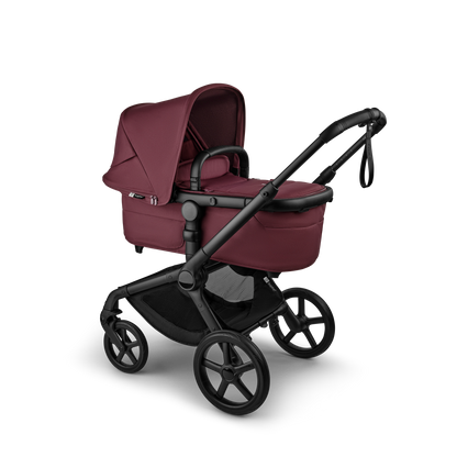 The dark cherry Bugaboo Fox5 pushchair, equipped with a seat and carrycot fabric, offers a compact fold for all-terrain use.