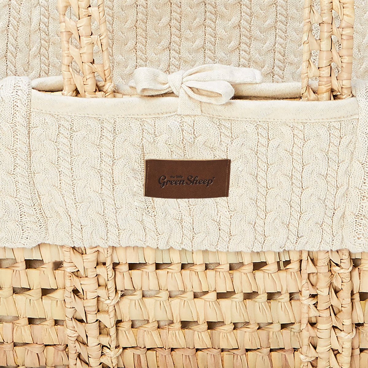 linen moses basket with a close up view of stitching