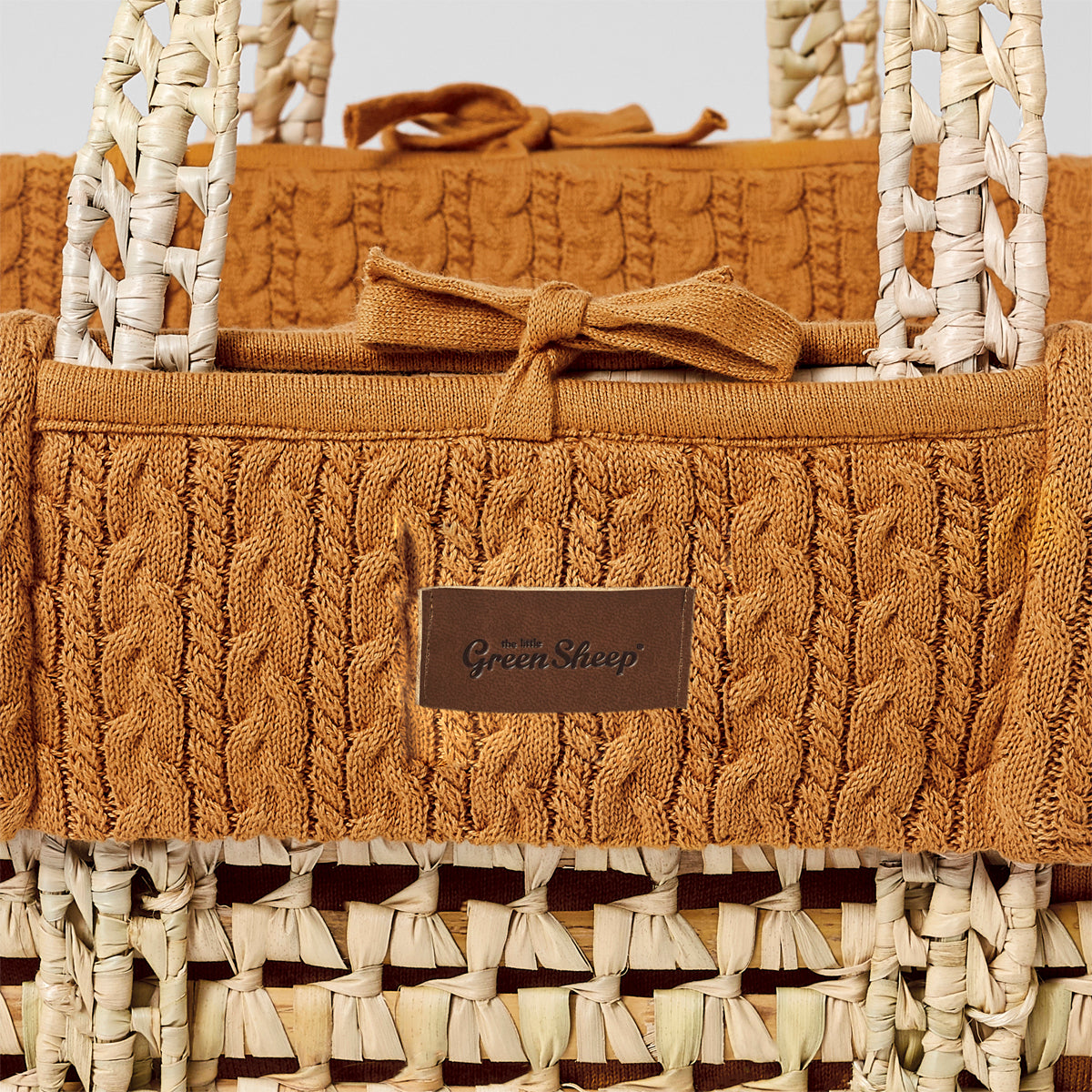 Honey moses basket with a close up view of stitching