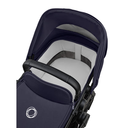 Bugaboo Cub stroller and carrycot in deep indigo blue with black chassis.