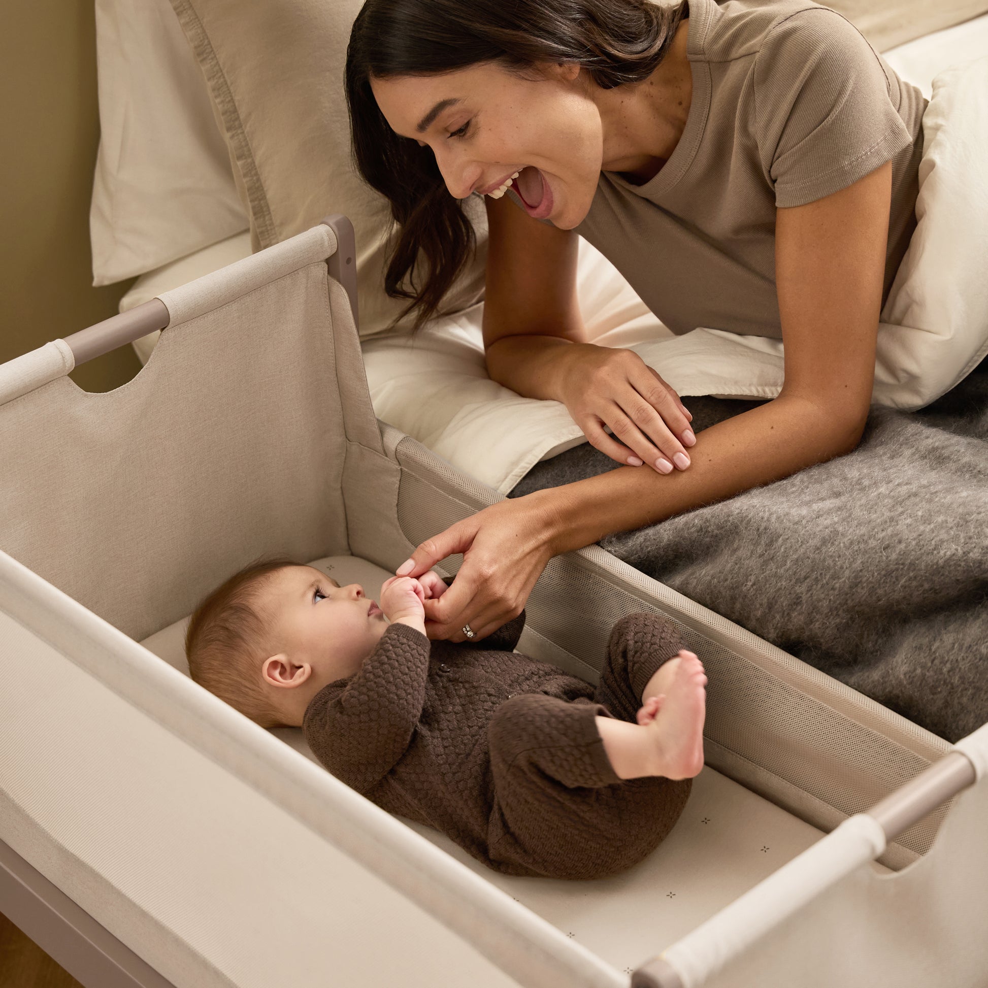 A Mocha Snuzpod5 bedside crib designed for infants, showcasing a modern and safe sleeping environment.