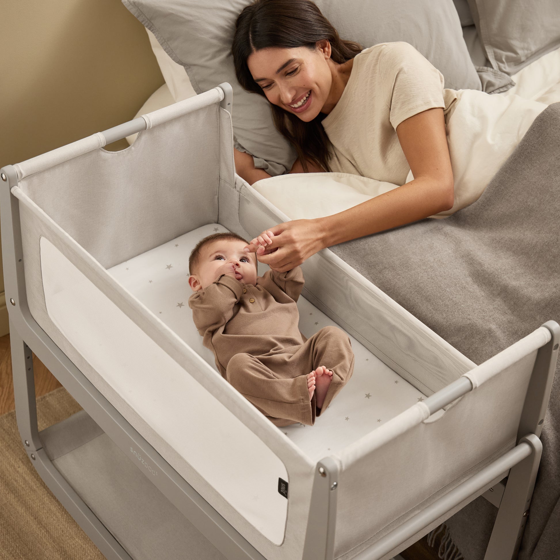 A Pebble Snuzpod5 bedside crib designed for infants, showcasing a modern and safe sleeping environment.