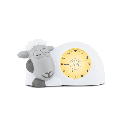 A white a grey sheep with a clock in its belly showing the different colours of its belly when the time changes.