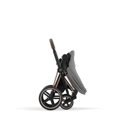 Cybex Priam rose gold chassis with dark brown handle and mirage grey seat pack.