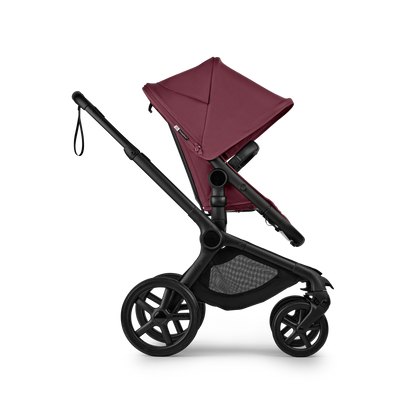 The dark cherry Bugaboo Fox5 pushchair, equipped with a seat and carrycot fabric, offers a compact fold for all-terrain use.