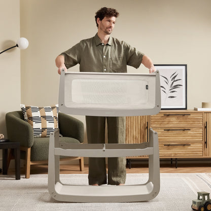 A Pebble Snuzpod5 bedside crib designed for infants, showcasing a modern and safe sleeping environment.